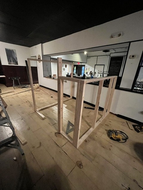 Bare timber framing standing in the empty dining room