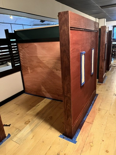 The first mahogany panel skinned, still taped at the base