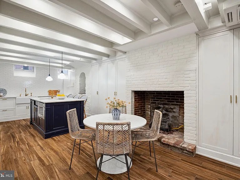 Beamed ceiling over a navy kitchen island