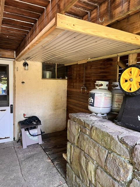 Covered outdoor bar in stone and timber
