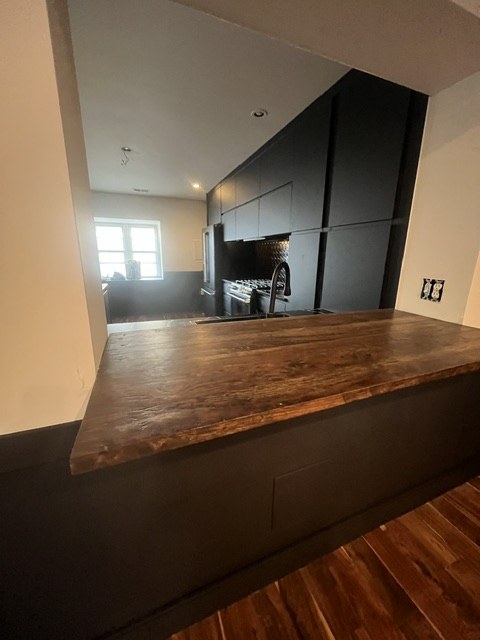 Walnut ledge against matte black cabinets