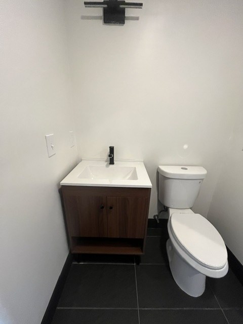 Walnut vanity and dark floor