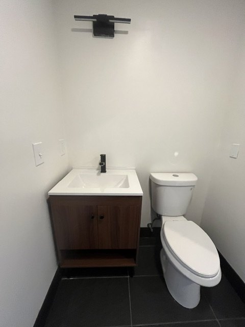 Walnut vanity and toilet on slate