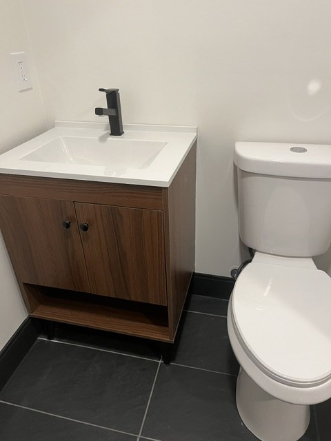 Walnut vanity beside a tiled floor