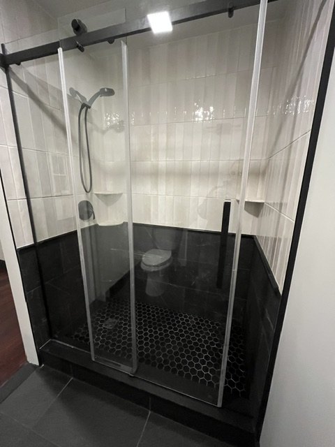 Glass shower on a black base
