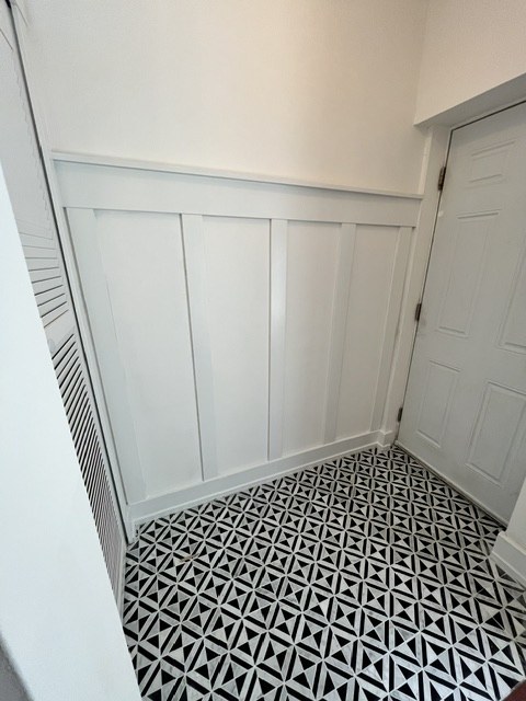 Patterned tile floor in a small bathroom