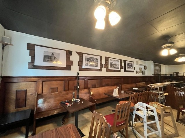 Dining room with wainscoting and framed prints