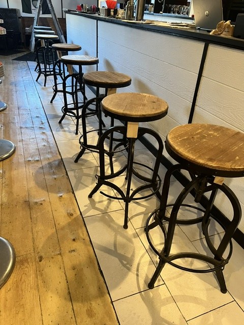 Bar stools along a plank floor